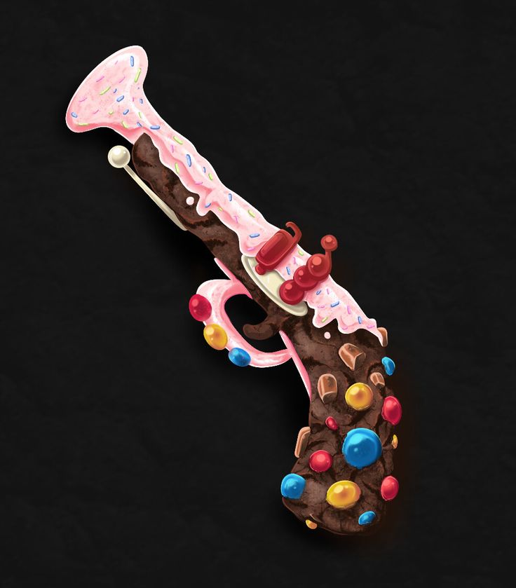 a chocolate and candy decorated hair clip on a black background