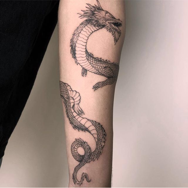 a person with a dragon tattoo on their arm