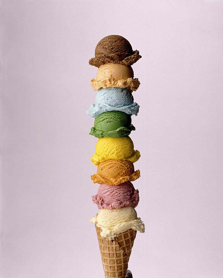 an ice cream cone filled with different colored icecream cones on top of each other