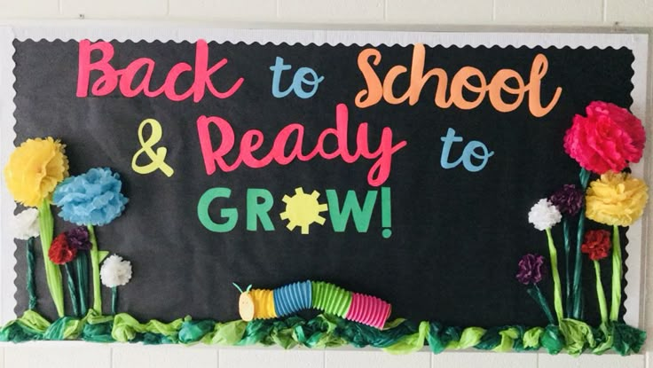 a back to school and ready to grow bulletin board with flowers on the front wall