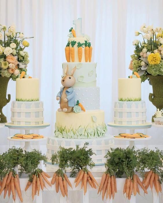 there are carrots and cake on the table with flowers in vases next to it