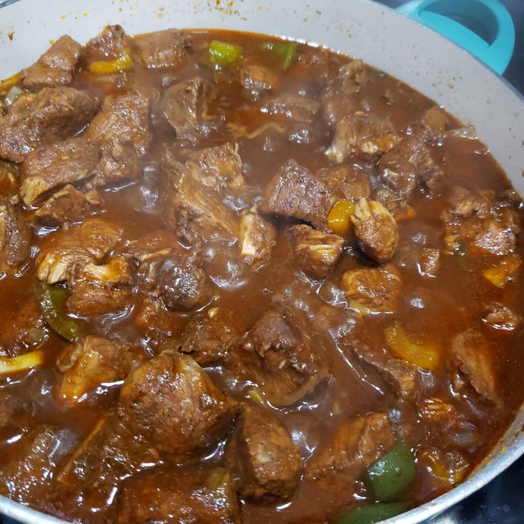 a pot filled with meat and vegetables on top of a stove