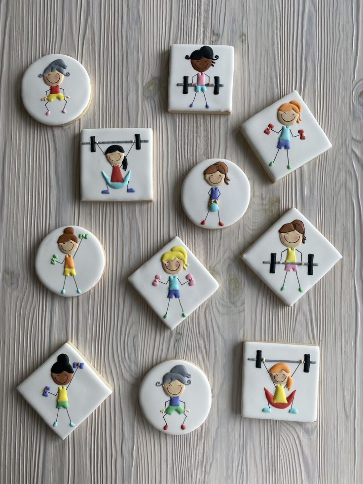 decorated cookies with children's drawings on them sitting on top of a wooden table