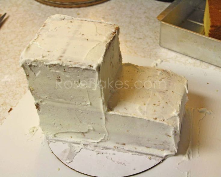 a piece of cake sitting on top of a white plate next to a mirror and knife