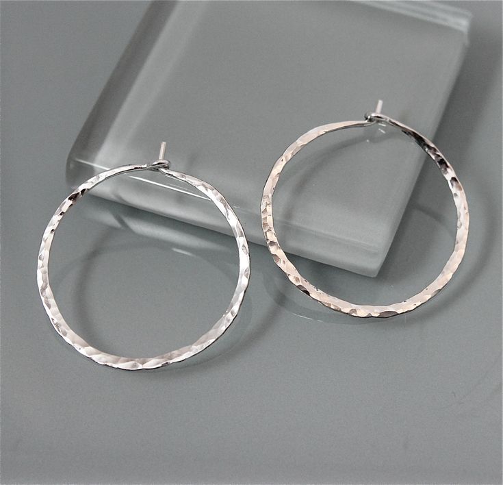 "These hoops are made of hand hammered 1mm thick sterling silver. Approx. 1\" diameter. They are bent and hammered and then polished to a glittery shine by me. A basic essential to have. All items are presented in a 100% recycled paper box with a paper raffia bow. Thank you for looking at my shop. http://www.etsy.com/shop/tinysparklestudio For vintage clothing and uniquities, check out my hubby's shop Joestitchn http://www.etsy.com/shop/JoeStitchn" Silver Earrings Hoops, Small Silver Earrings, Small Silver Hoop Earrings, Simple Hoop Earrings, Hammered Hoop Earrings, Hammered Sterling Silver, Large Hoop Earrings, Sterling Silver Hoop Earrings, Hammered Silver