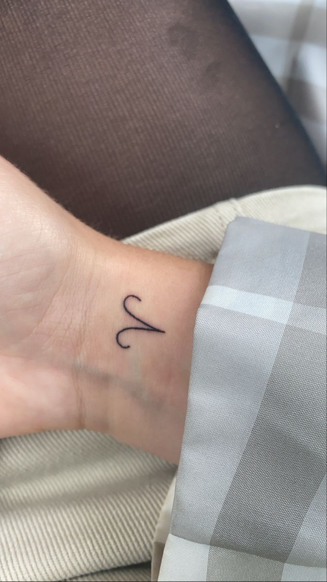 a person with a small tattoo on their wrist