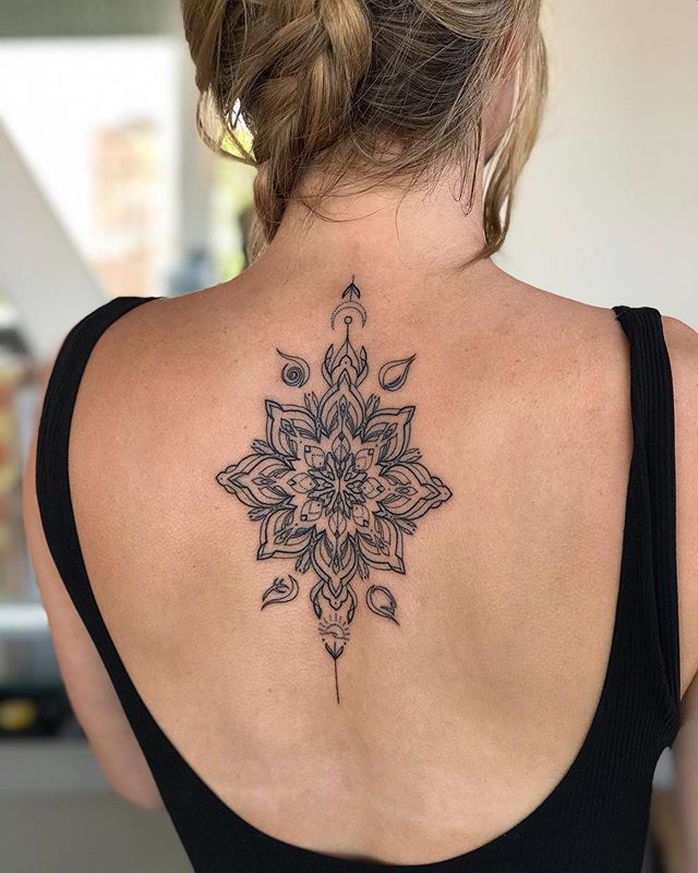 a woman with a tattoo on her back