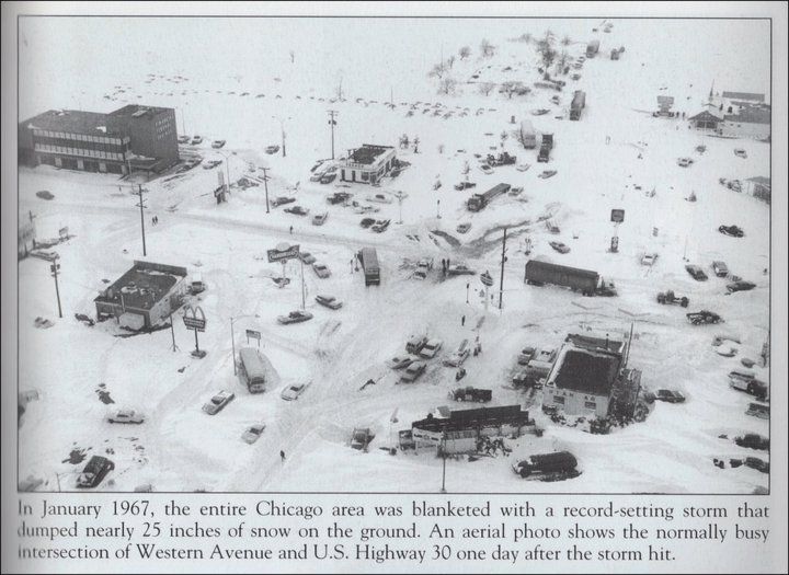 an old black and white photo of cars parked on the side of a snow covered road