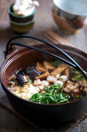 a bowl filled with soup sitting on top of a wooden table