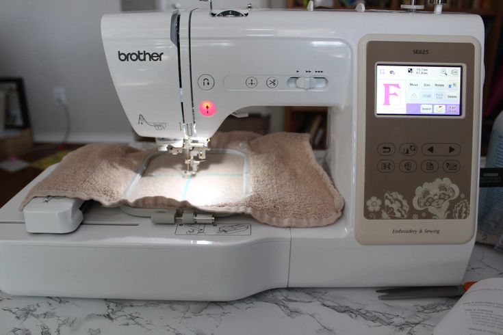 a sewing machine with a light on it sitting on top of a marble countertop