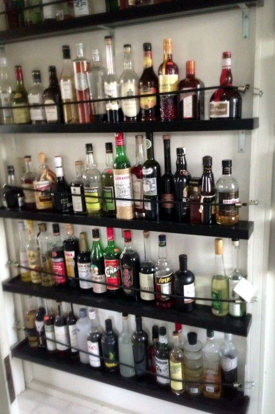 the shelves are filled with liquor bottles