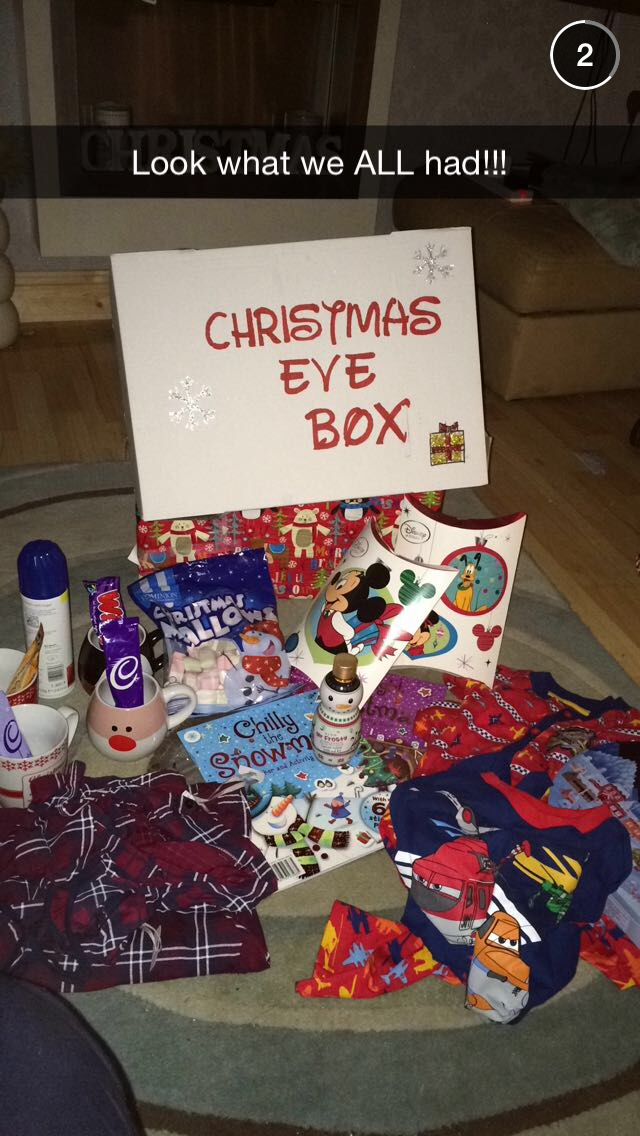 a christmas eve box is sitting on the floor next to a sign that says, look what we all had