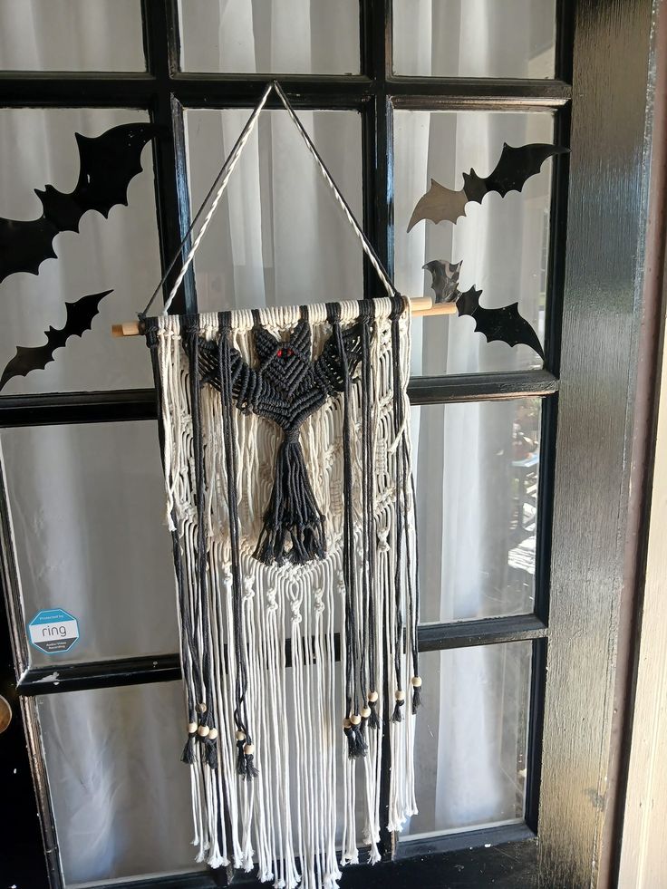 a bat decoration hanging from the side of a door