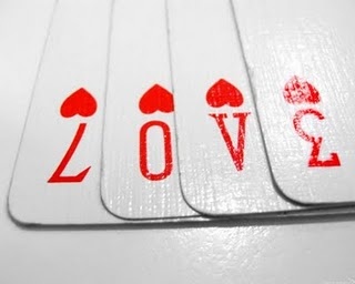 four playing cards with the word love printed on them