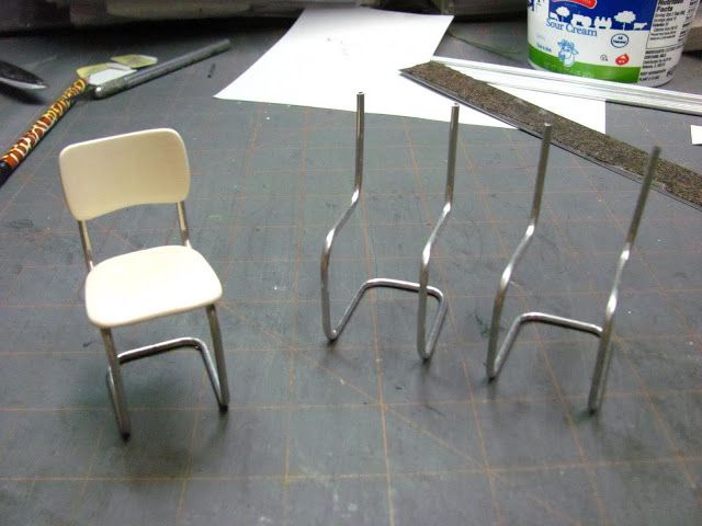 two chairs sitting next to each other on top of a table with construction tools nearby