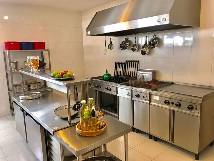 a kitchen with stainless steel appliances and white tile flooring is pictured in this image