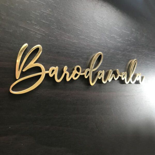 the name barogana on top of a black table with gold lettering in cursive font