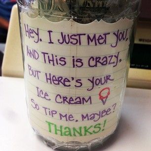 a jar filled with lots of money sitting on top of a table