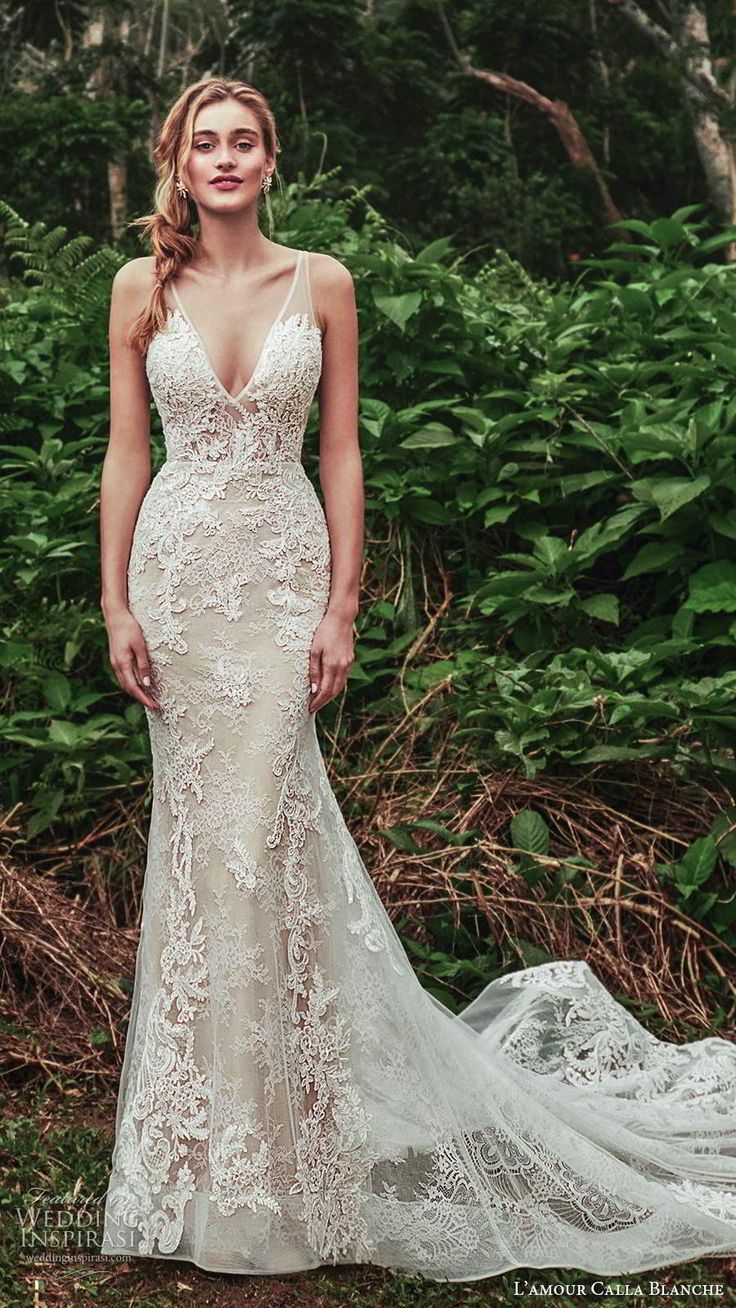 a woman standing in front of bushes wearing a wedding dress with an open back and straps