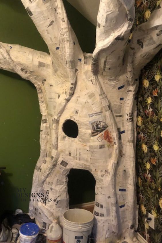 there is a paper mache tree that looks like it has been made into a house