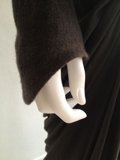 a mannequin's head wearing a black dress