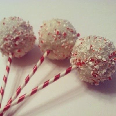 three lollipops with sprinkles on them are sitting next to each other