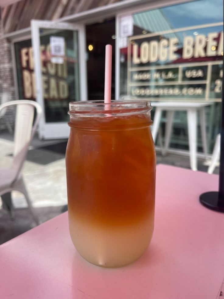 a drink sitting on top of a pink table