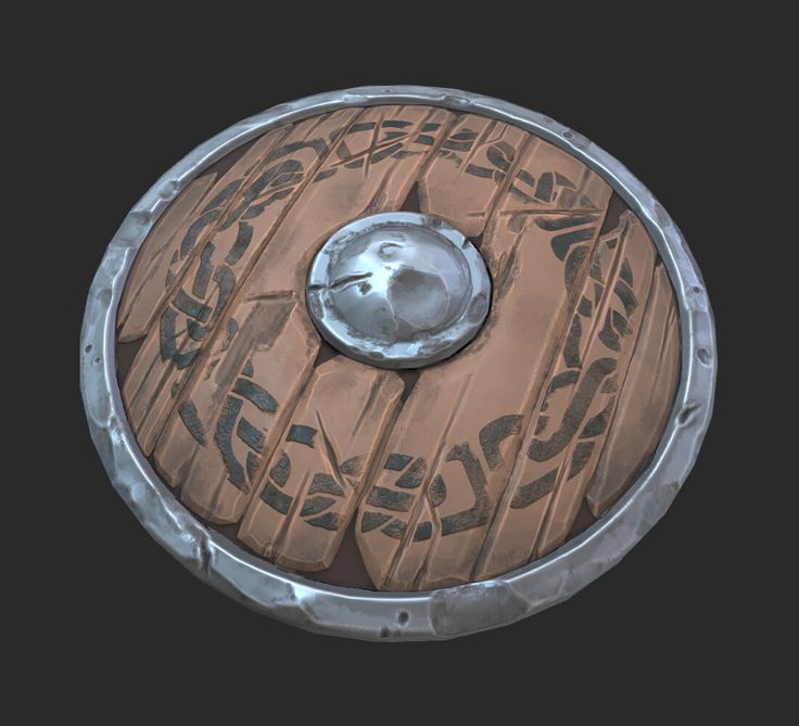 a wooden shield with metal decoration on it