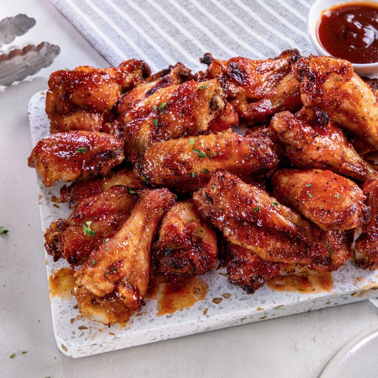 chicken wings on a plate with dipping sauce