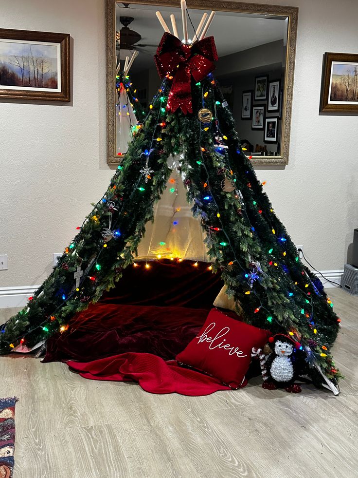 a teepee decorated with christmas lights and decorations