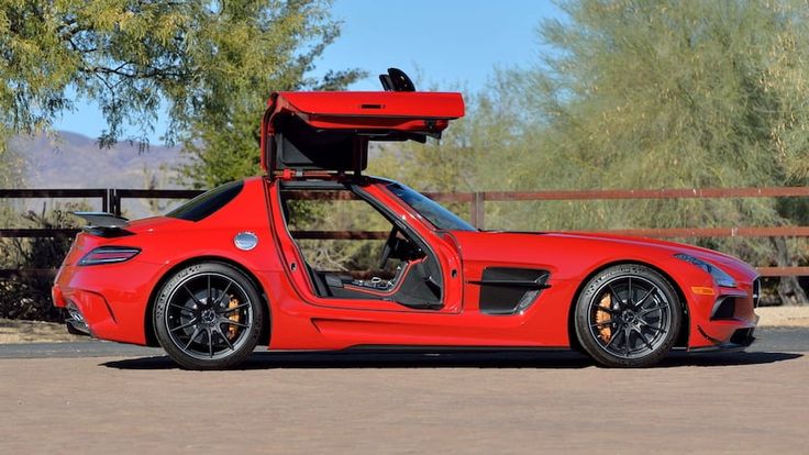 a red sports car with its doors open