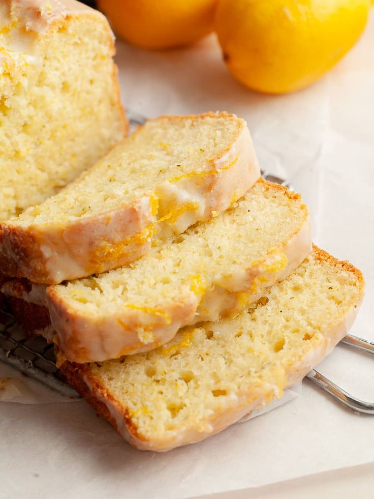 slices of lemon bread sitting on top of a white paper towel next to oranges