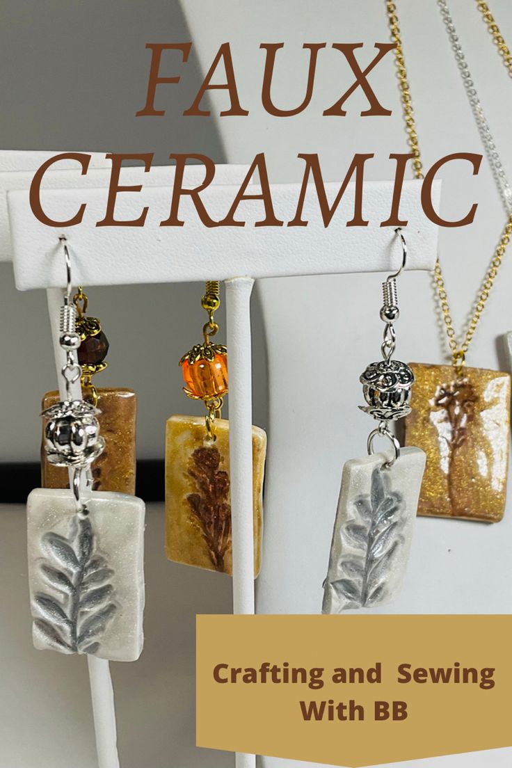 three pendants are hanging on a white rack with the words faux ceramic crafting and sewing with bj