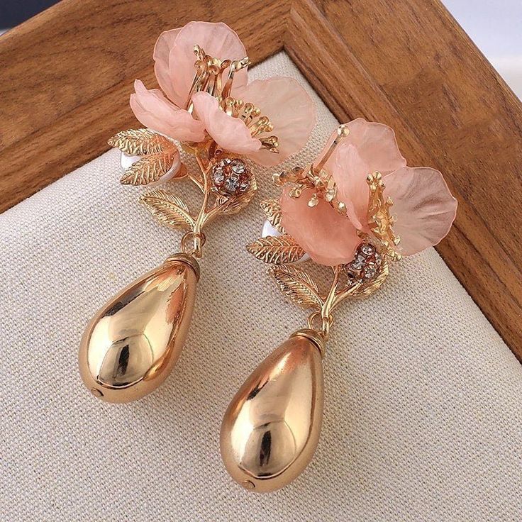 ♡ Large Magnolia Flower Earrings ♡ Our Golden Vase Drop Magnolia Flower Dangling Earrings are the cutest vintage-style chic look that is sure to compliment any outfit! These long vase-like gold drops are light weight and super comfy to wear. Perfect dainty costume jewelry gift for birthdays and special occasions. Size: 2.5 inch Material: alloy steel brass, pearls, crystal with gold finish W H Y ∙ Y O U ' L L ∙ L O V E ∙ I T • They are beautiful dangle earrings that can be worn every day with any Prom Gift, Earrings Golden, Flower Water, Gold Bridal Earrings, Nature Earrings, Alloy Earrings, Professional Jewelry, Large Earrings, Metal Earrings