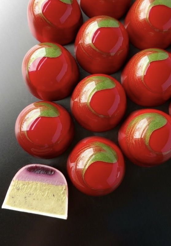 a pile of red balls sitting on top of a table