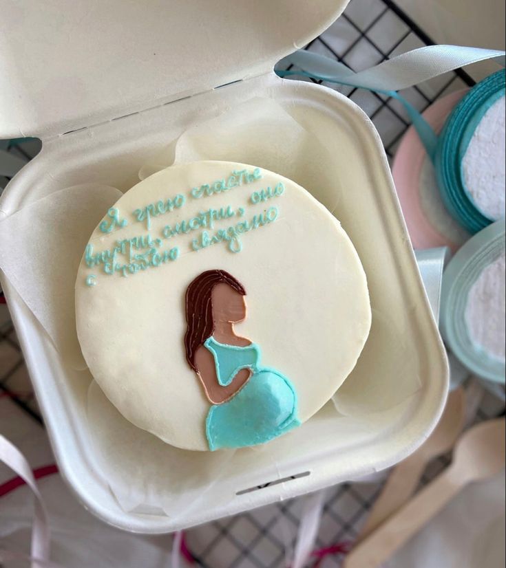 there is a decorated cookie in the shape of a pregnant woman