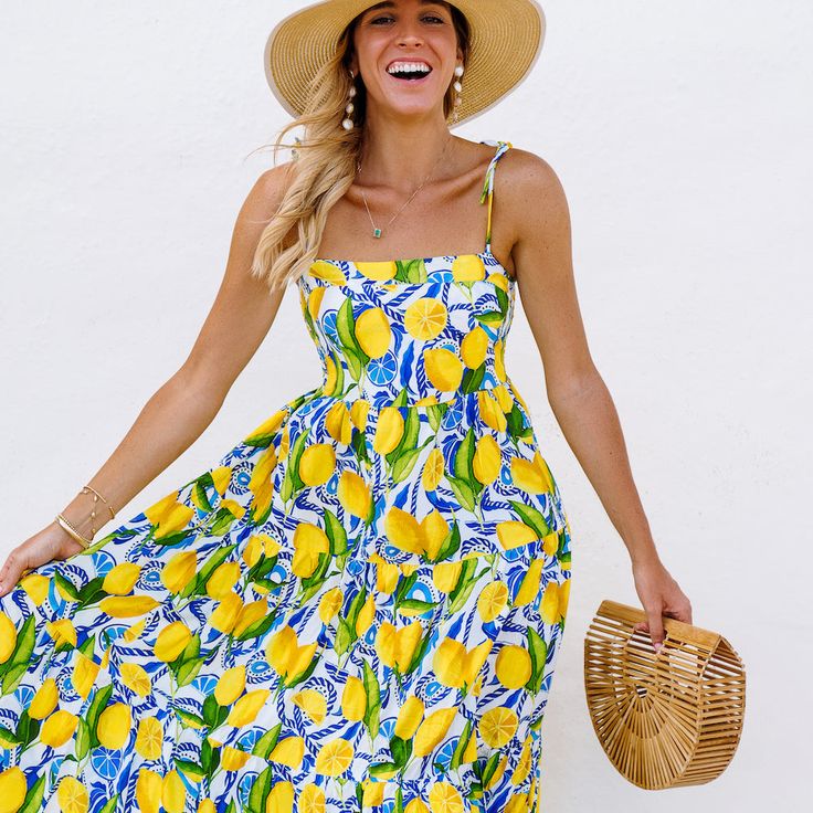 Soak up the sun, the briny breezes — and maybe brush up on your Italian while you’re at it in this lemon dress. The Positano - Resort Dress is sure to give you that “endless summer” energy on vacation and around town on your Vespa.Steal the spotlight solo, or match it up with your main squeeze in The Bossitano shirt. Details Hand-cut and made ethically in Bali, limited edition 100% organic rayon resort dress Stretchy, smocked back for a custom fit Flowy, tiered maxi dress bottom Adjustable tie s Amalfi Style, Amalfi Coast Outfits, Honeymoon Itinerary, Kenny Flowers, Coast Outfit, Resort Dress, Italy Honeymoon, Travel Chic, Packing Guide