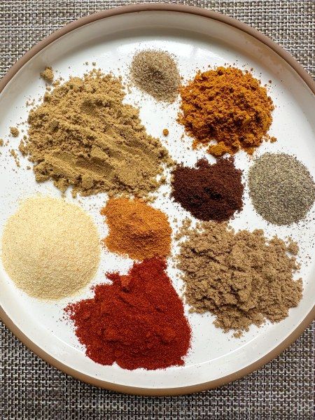 a white plate topped with lots of different types of spices