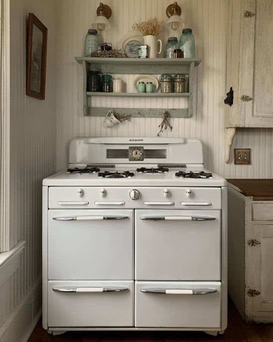 an old fashioned white stove in a kitchen