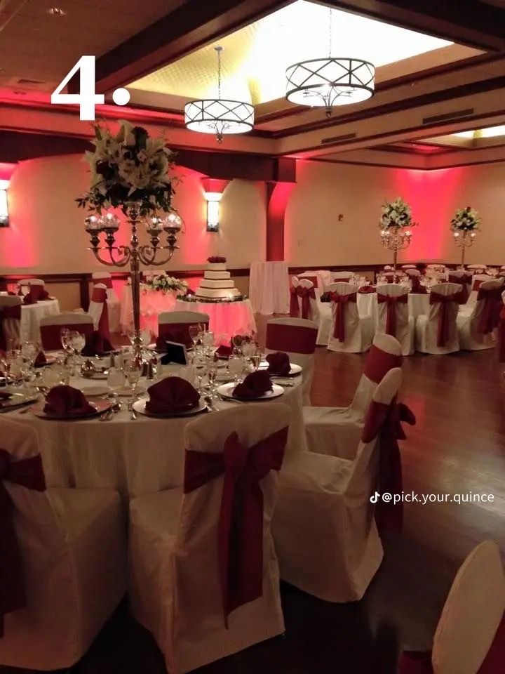 the banquet room is decorated with red and white linens