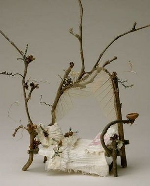 an image of a fake tree that is made out of paper and branches with flowers on it