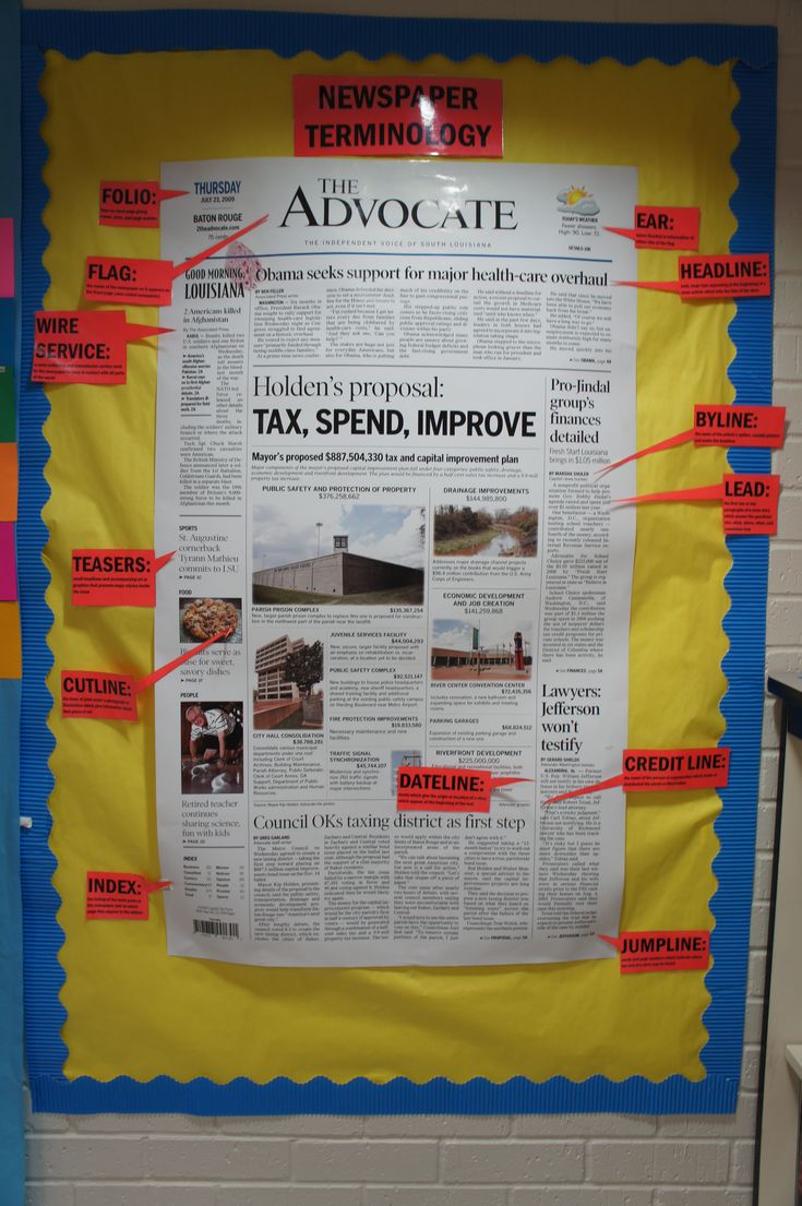 a bulletin board that has been taped to the wall with newspaper clippings on it