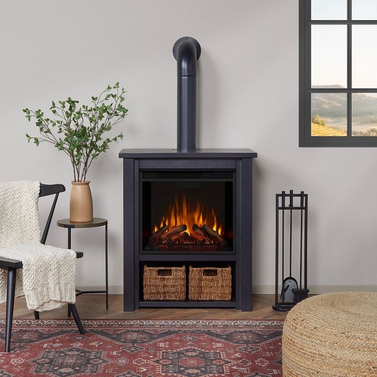 a living room with a fire place in the center and a chair next to it