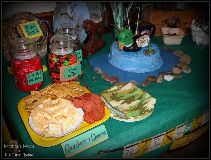 a table topped with lots of food and condiments on top of green cloth