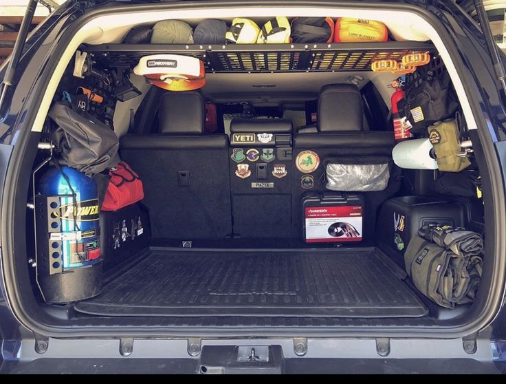 the back end of a vehicle with its cargo compartment open and various items in it