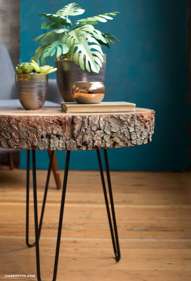 two potted plants sitting on top of a wooden table