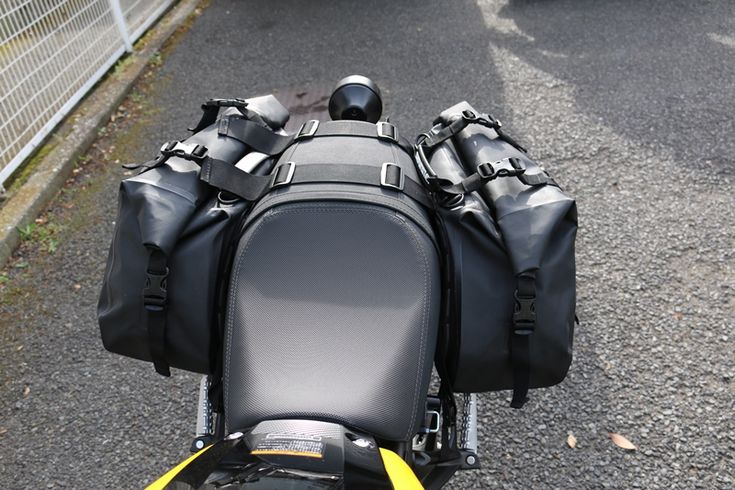 the back end of a motorcycle with luggage strapped to it