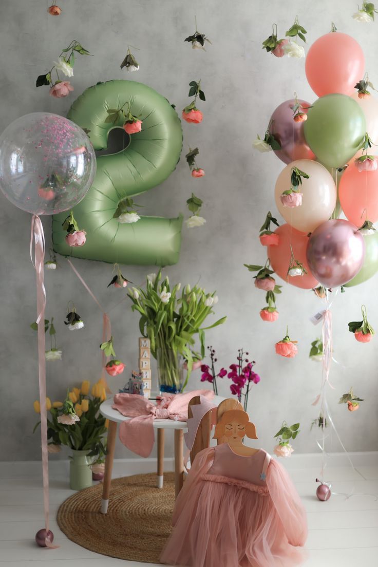 the balloons are in the air and there is a small table with flowers on it