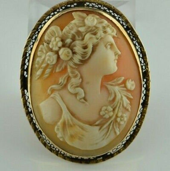 "Vintage 14K Yellow Gold Portrait Cameo Pin, nicely carved woman florals in hair, and bodice domed cameo shell oval filigree set, 1.75\" x 1 3/8\" overall, Circa 1940, 11.8 grams Stock # BB163L14 This listing contains photographs of the actual item you will receive. Our items are in excellent condition with little or no signs of wear and many are one of a kind pre-owned estate finds. Please look closely at the pictures in this listing as they are part of the product description. Please read the Gold Portrait, Cameo Jewelry, Vintage Inspiration, Fine Jewelry Designers, Blue Topaz Ring, Vintage Watches, Jewelry Ideas, Antique Jewelry, Vintage Antiques