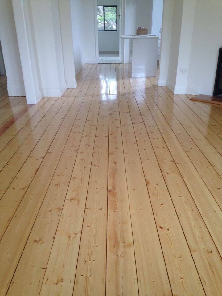 an empty room with hard wood floors and white walls